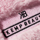 Close-up of the Kemp Beauty branded tag on the travel bag