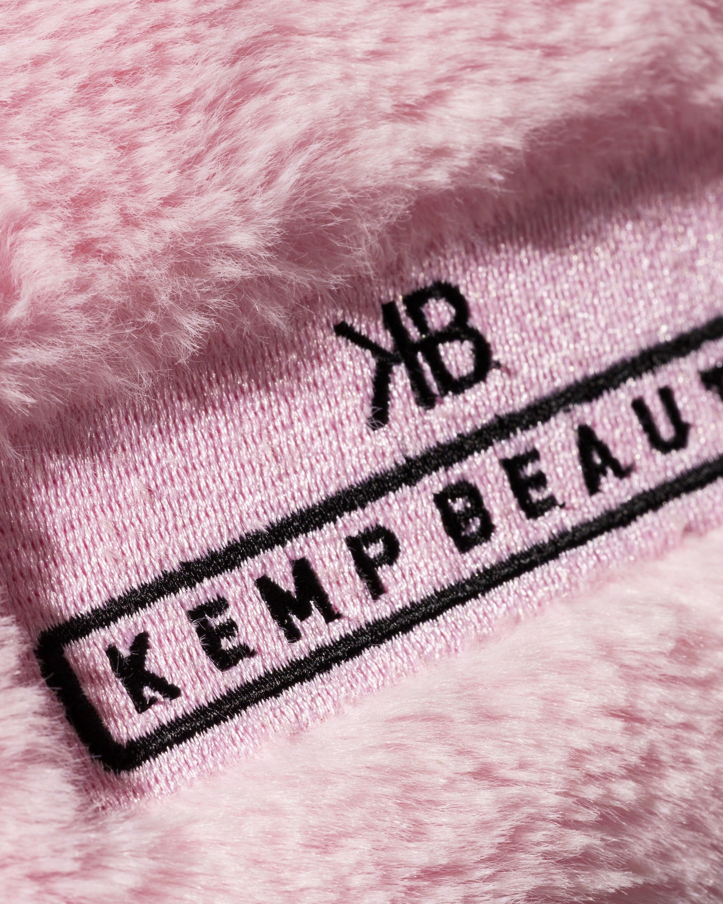 Close-up of the Kemp Beauty branded tag on the travel bag