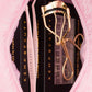 Open Kemp Beauty travel bag with curler, tweezers, and lash cluster box inside