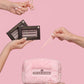 Hands holding the curler, lash cluster boxes, tweezers, and travel bag from the Max Performance Lash Kit