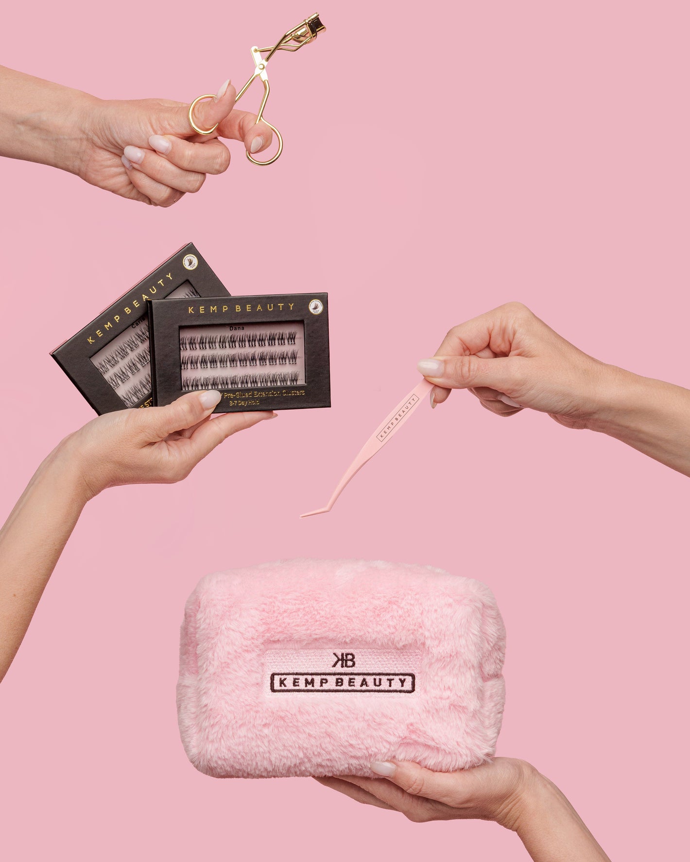 Hands holding the curler, lash cluster boxes, tweezers, and travel bag from the Max Performance Lash Kit