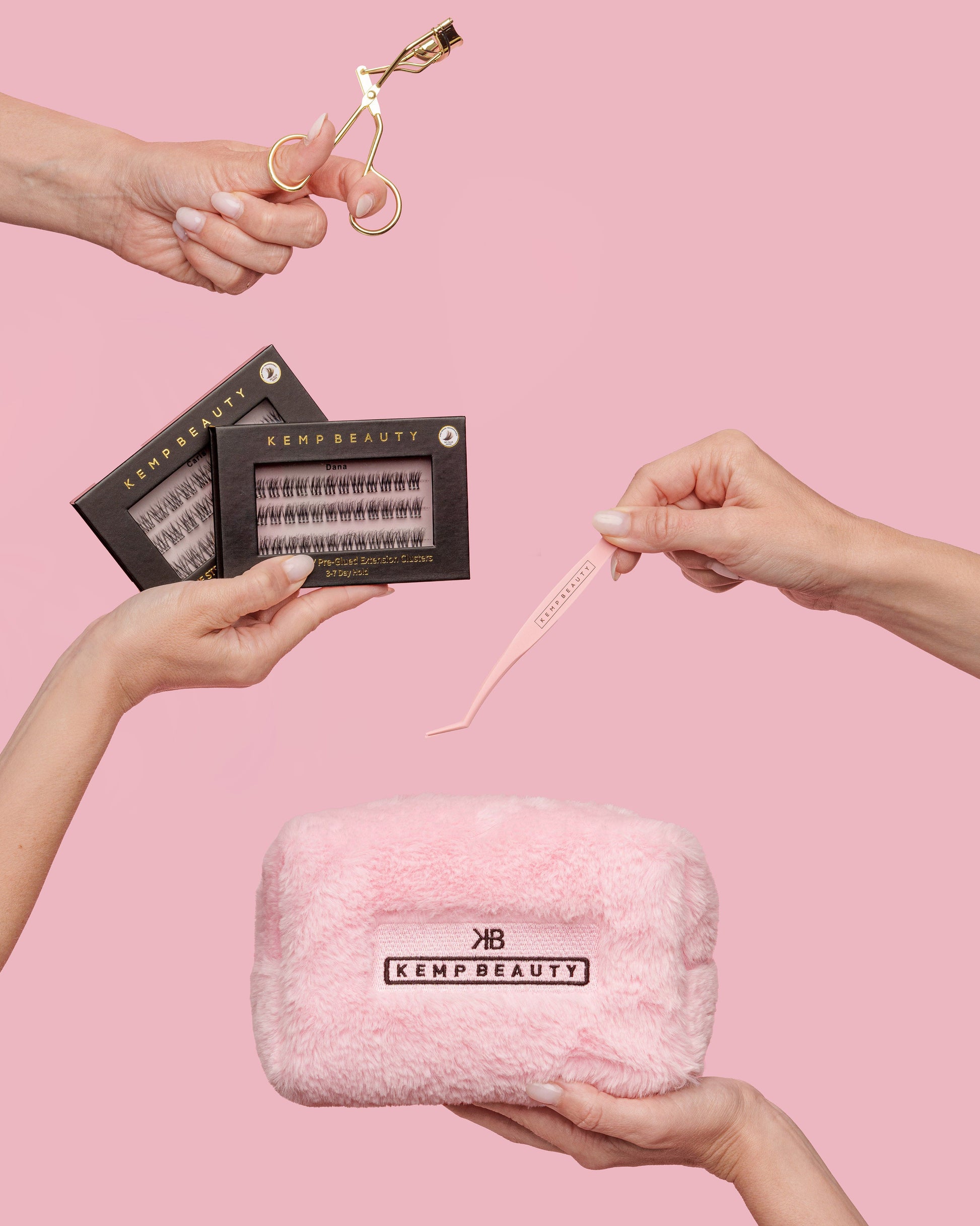 Hands holding the curler, lash cluster boxes, tweezers, and travel bag from the Max Performance Lash Kit