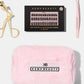 Flat lay of curler, lash cluster box, tweezers, and travel bag from the Max Performance Lash Kit
