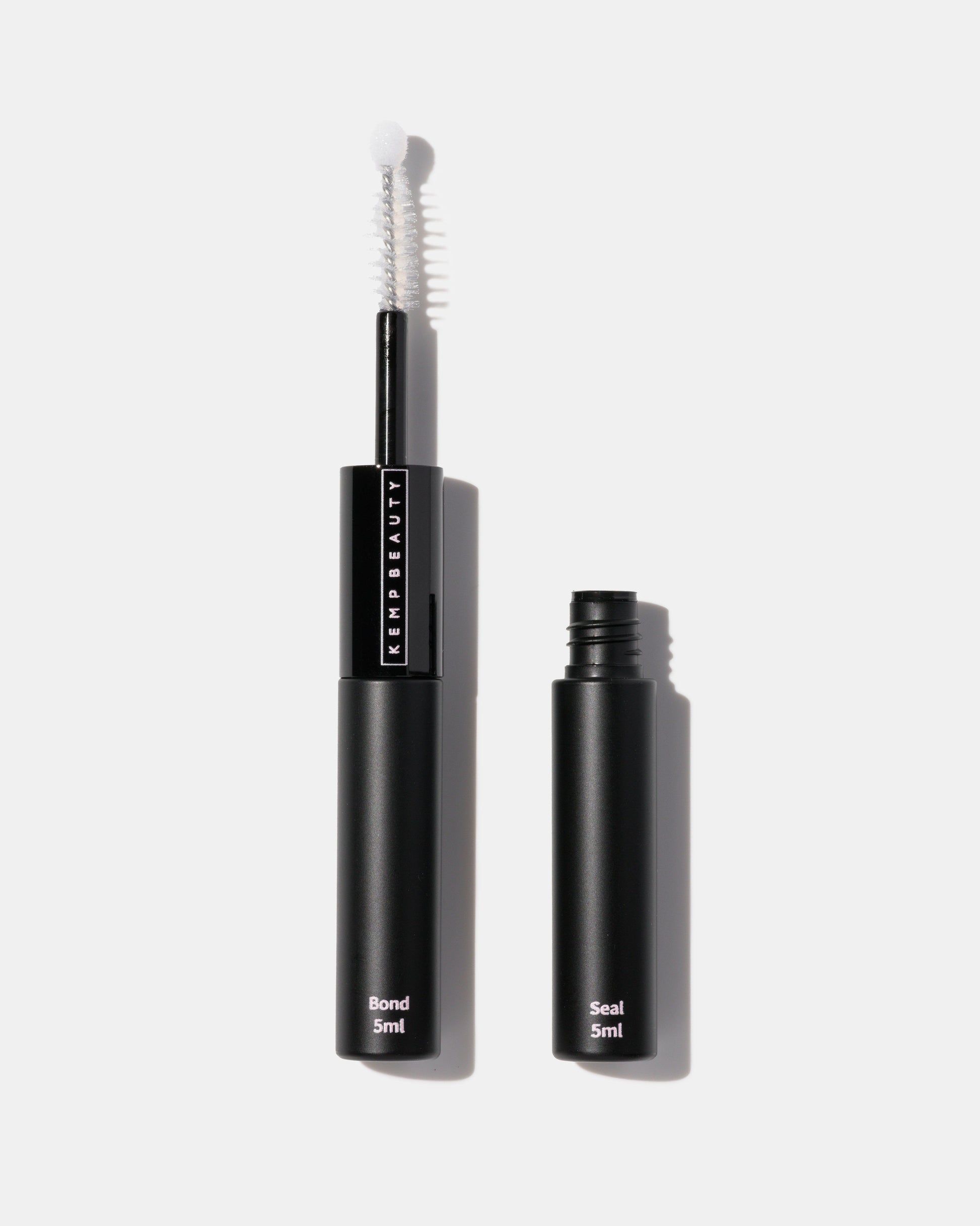 Black eyelash serum with applicator on a white background